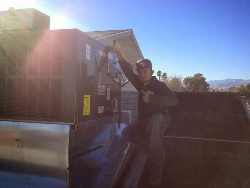 HVAC technician performing HVAC Inspection on a rooftop unit in Mill Creek East